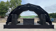 Konligo Fastival structure with black membrane cover set up outdoors on a concert stage, now available on MTN Shop US. - imagen 8