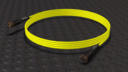 Coiled yellow P26 remote control cable with black circular connectors at both ends, displayed on a dark textured background.